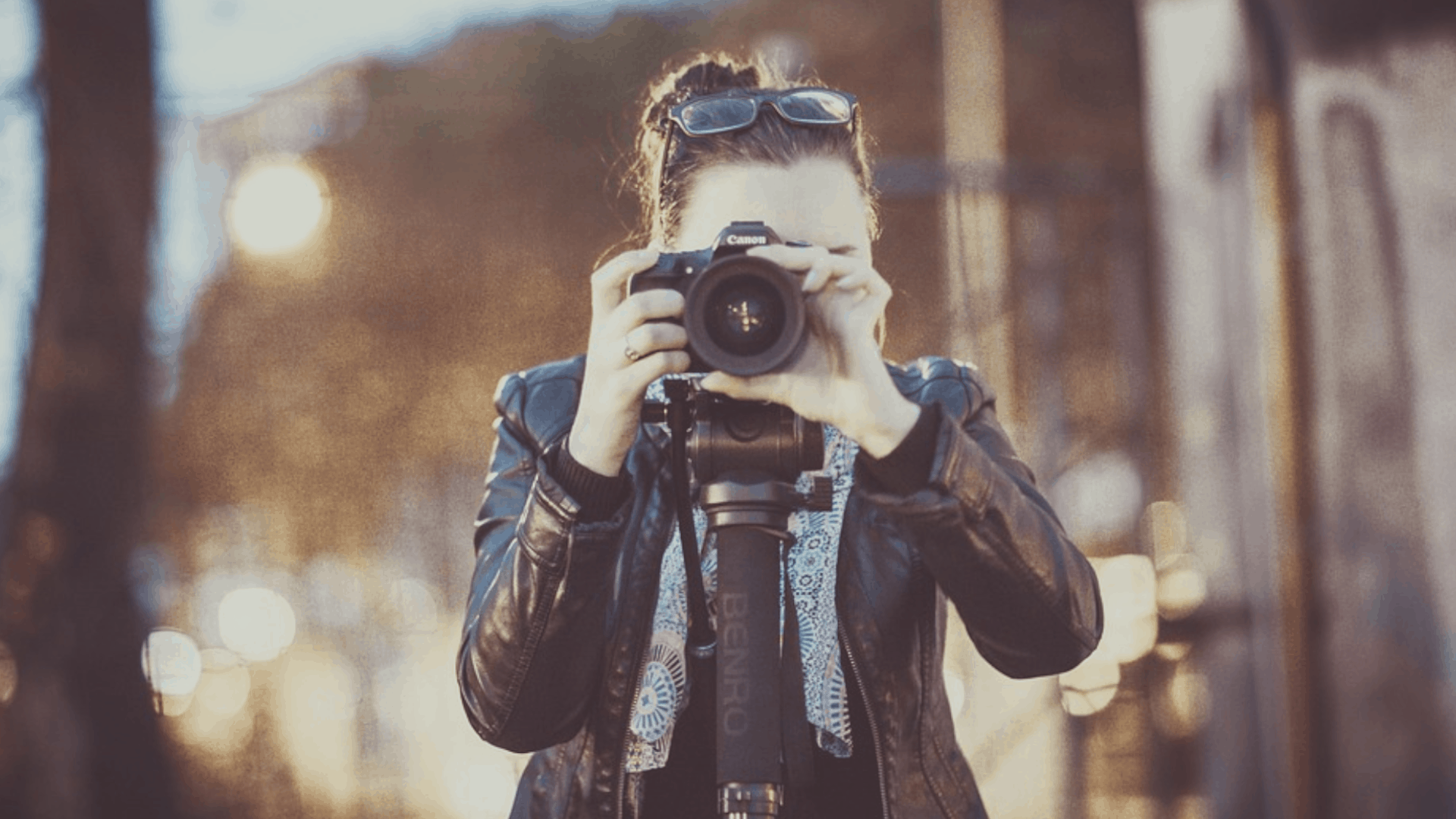 Woman behind camera taking a picture