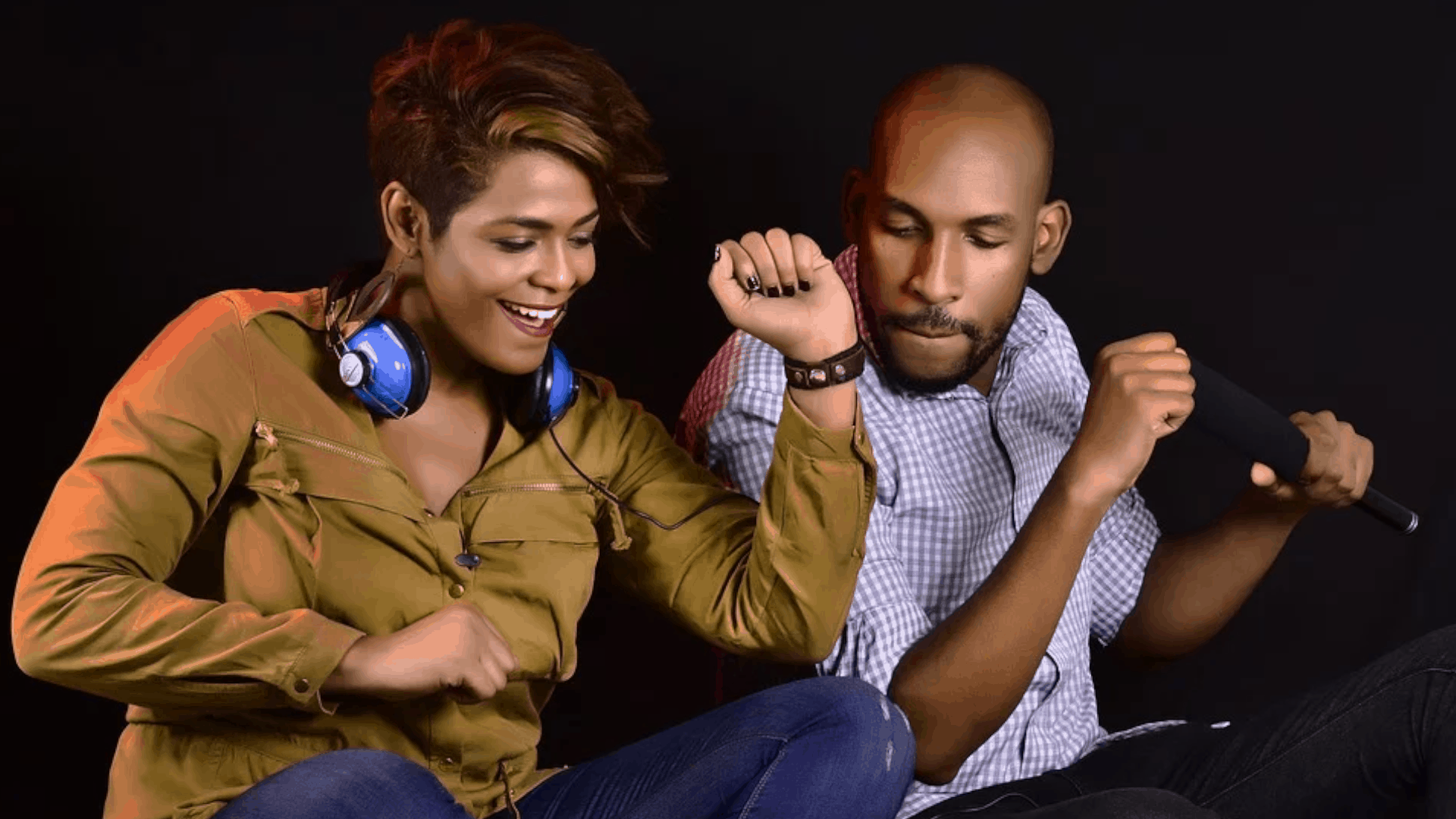 two people dancing with headphones and a microphone