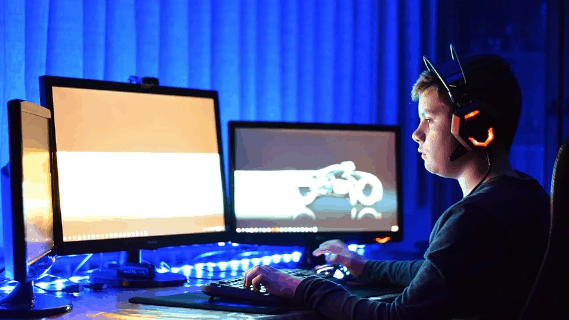 person gaming on multiple screens